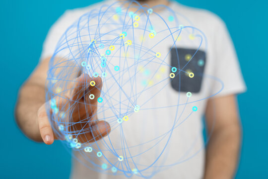 A man interacts with a digital sphere representing global connections and network data.