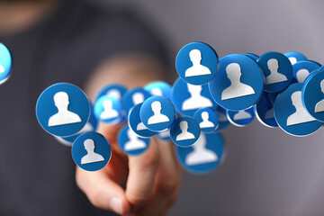 Hand interacting with digital profile icons. Social media, networking, connection concept.