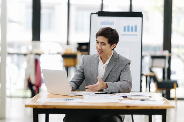 Business Communication and Innovation: A businessman actively engages in a video conference,...