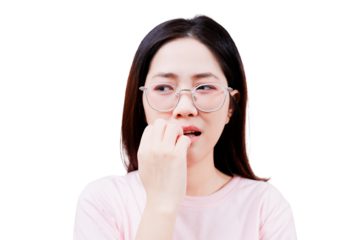 A young woman with glasses appears anxious, biting her nails while looking to the side.