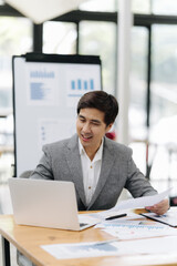 Business analytics at the office: a focused professional analyzes financial reports, embodying strategic thinking in a modern office environment. 