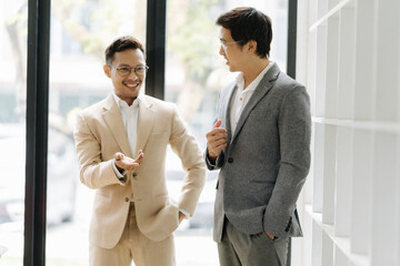 Business Colleagues Collaboration: Two business colleagues engaged in a discussion. the setting sun casts a warm glow, and embodies the spirit of collaboration.
