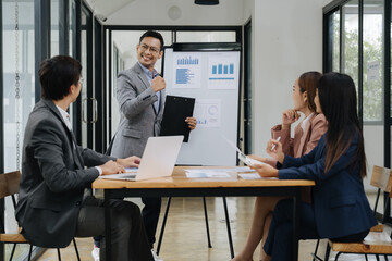 Meeting's Success: A business presentation unfolds as a group of professionals engages in a...