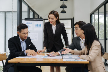 Strategic Session: A dynamic business meeting unfolds as professionals gather around a conference...
