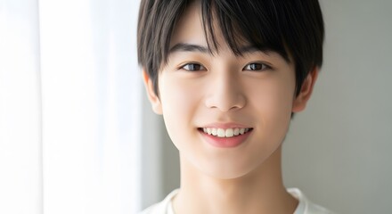 Portrait of a Smiling Asian Teenager with Short Black Hair