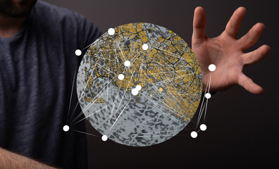 A man interacts with a digital globe showcasing city networks and global connections.