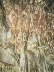 Abstract drawing of an underground cave with stalactites and stalagmites. Limestone karst formation. Travel and vacation concept. Digital painting. Abstract naturalism, relief pattern.