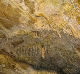 Abstract drawing of an underground cave with stalactites and stalagmites. Limestone karst formation. Travel and vacation concept. Digital painting. Abstract naturalism, relief pattern.