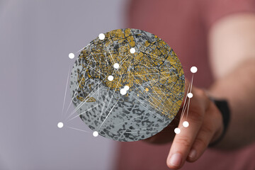 Person interacting with a digital globe, showcasing interconnected global network. Modern...