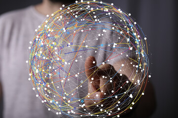 Person interacts with a digital globe, representing global connectivity and networking.