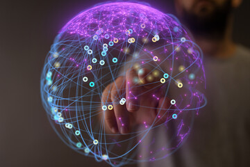 Abstract image of a hand interacting with a digital global network. Represents connection,...