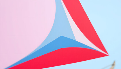 Closeup of a red, blue and white sail on a sailboat, papercraft. White tone