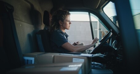 Female Delivery Truck Driver in Car Using Tablet Computer, Filling Out Papers, Delivering Cardboard...
