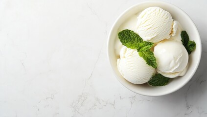 Three scoops of vanilla ice cream in a white bowl, garnished with fresh mint leaves, on a white marble surface (1)