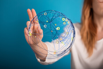 Stock photo of a woman interacting with a digital globe representing global network connections.