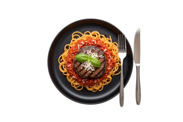 Top view of grilled steak served on spaghetti with tomato sauce, grated cheese, and basil leaves on a black plate with fork and knife