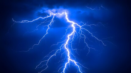 Powerful lightning strikes against a dark blue sky.