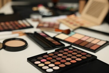 Different makeup products on dressing table, closeup