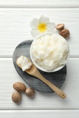 Natural shea butter on white wooden table, flat lay