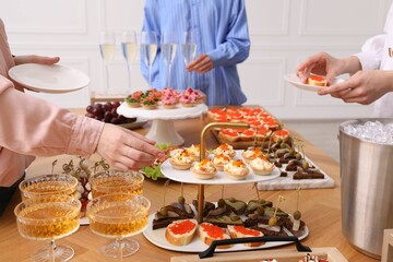 People with different appetizers at buffet, closeup