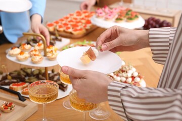 People with different appetizers at buffet, selective focus