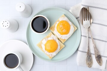 Tasty kaya toasts with half-boiled eggs served on white tiled table, flat lay. Traditional asian...