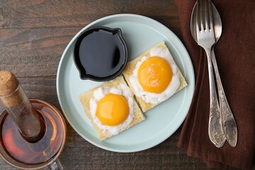 Tasty kaya toasts with half-boiled eggs served on wooden table, flat lay. Traditional asian breakfast