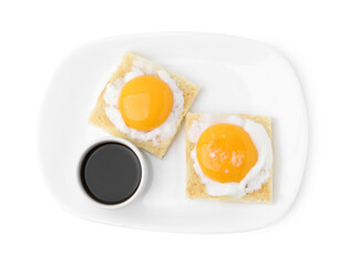 Tasty kaya toasts with half-boiled eggs and soy sauce isolated on white, top view. Traditional asian breakfast