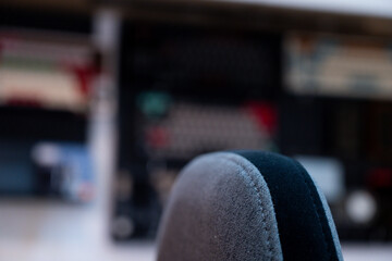 A detailed view of a modern and organized workspace, showcasing dual monitors displaying dynamic blue visuals, complemented by indoor plants and a collection of mechanical keyboards.