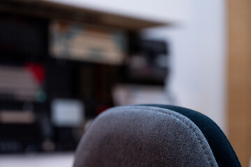A detailed view of a modern and organized workspace, showcasing dual monitors displaying dynamic blue visuals, complemented by indoor plants and a collection of mechanical keyboards.