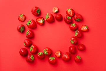 Frame of fresh ripe strawberries on red background, flat lay. Space for text