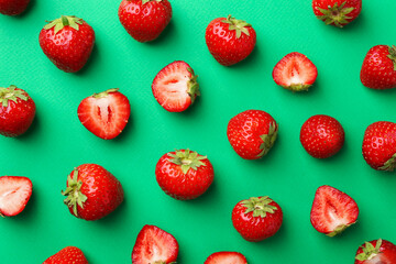 Fresh ripe strawberries on green background, flat lay