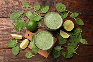 Tasty spinach smoothie and ingredients on wooden table, flat lay