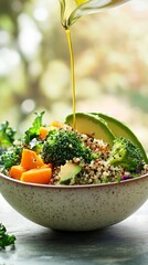 A bowl with quinoa, broccoli, avocado slices, roasted pumpkin cubes, and olive oil