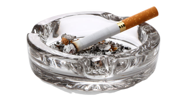 A burning cigarette in a glass ashtray