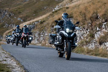 Bikers riding powerful motorcycles on scenic mountain road