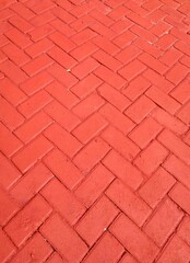Close-up of a textured brick path with geometric patterns, showcasing the urban ground surface