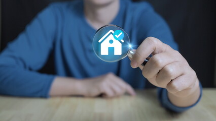 magnifying glass focuses on a digital house icon, representing property search, online real estate analysis, home inspection, and smart property technology. visuals related to housing market research