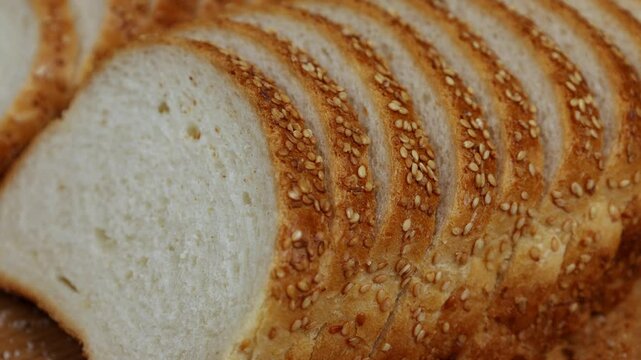 Close-up of fresh bread slices being quickly taken apart in a time-lapse video