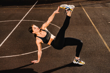 Fitness woman doing yoga fitness stretching pilates exercise for body health in the park, outdoor...