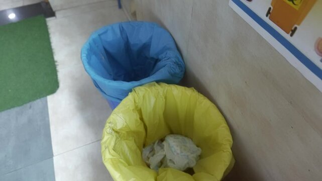 Hospital garbage segregation setup with separate bins for different waste types, showcasing sanitation practices, infection control, and medical waste disposal