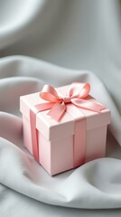 Pastel gift box with silk ribbon on fabric — vertical mockup for product packaging and branding visuals
