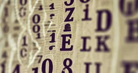 Close-up of hanging paper strips with numbers and letters, creating a vintage, textured pattern. - Powered by Adobe