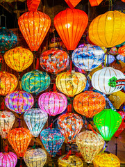 A kaleidoscope of traditional Vietnamese lanterns glowing in vivid colors during a market display