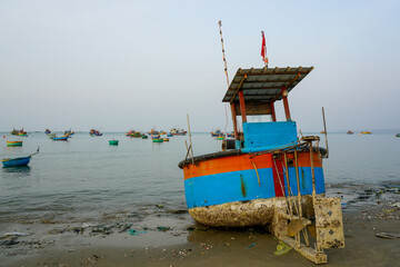 Colorful Fishing Boat Beached at Dawn in Mui Ne with Fleet in the Background