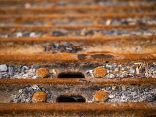 The rusty tracks of a machine are shown in the image. The tracks are old and worn, and the machine...