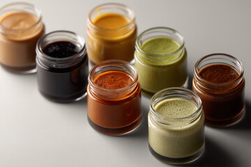 variety of homemade sauces arranged neatly on clean background