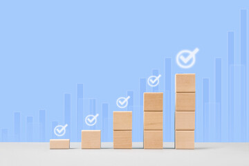Wooden blocks in form of graphical steps up of business growth process, start-up, business goals...