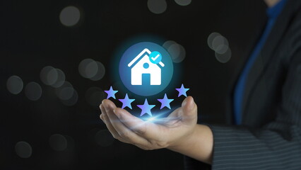  businessman presents a house icon with five stars, representing the sale of high-quality housing estates, trusted property brands, and premium real estate services.