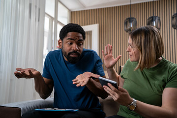 Angry Woman Arguing with Her Helpless Husband at Home Over Financial Problems, High Living Costs,...